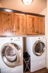 Laundry room with full-sized washer and dryer for easy clean up